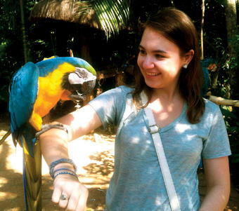 Shayna Orens ’15 poses with a macaw at Parque das Aves in Brazil, where she studied abroad during summer 2012. 